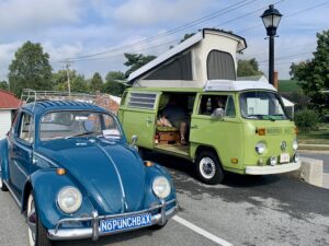 Old blue Volkswagen and old green VB Bus at Historic Red Fire Truck at Vintage Vehicles in the Valley